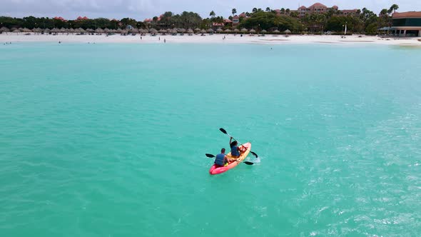 Couple Kayaking in the Ocean on Vacation Aruba Caribbean Sea Man and Woman Mid Age Kayak in Ocean