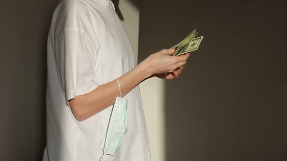 Woman hands holding one hundred dollar bills.