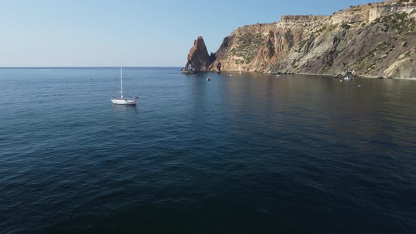 Aerial View From Above on Calm Azure Sea and Volcanic Rocky Shores