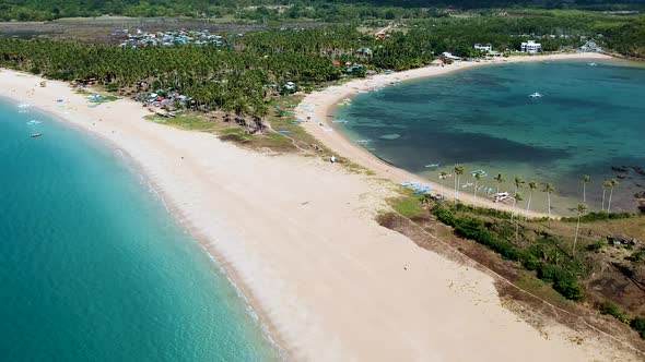 Cinematic aerial reveal of Double beach at Nacpan beach, El Nido , Palawan, Philippines