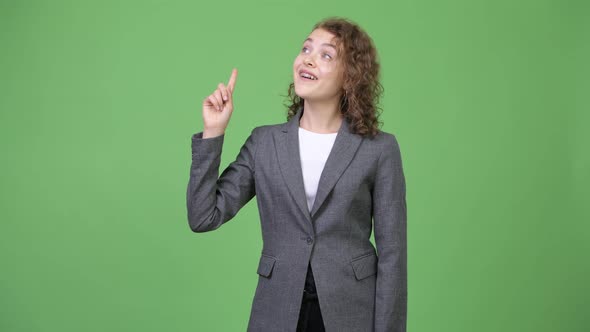 Young Happy Beautiful Businesswoman Thinking While Pointing Up