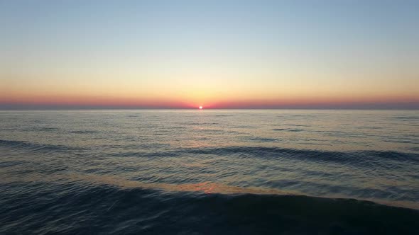 Aerial shot of waves on Lake Michigan at sunset