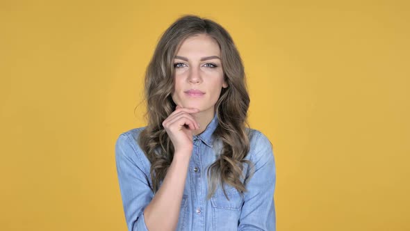 Thinking Young Girl Got New Idea Isolated on Yellow Background