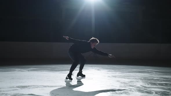 Professional Male Figure Skater Performs a Complex Figure Skating Element Flawlessly