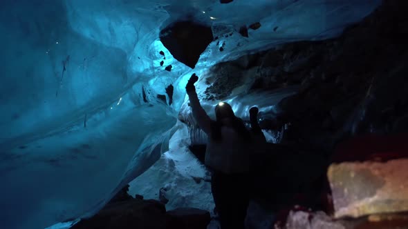 A Girl Touches Centuriesold Ice in an Ice Cave