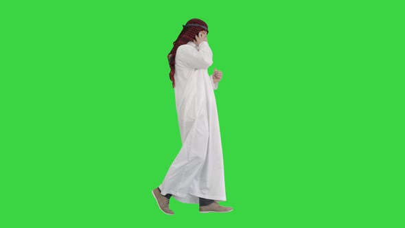 Arab Sheikh Making a Call Walking on a Green Screen, Chroma Key.