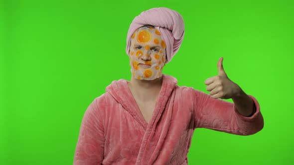 Transsexual Man in Bathrobe with Face Mask Giving Thumbs Up. Chroma Key