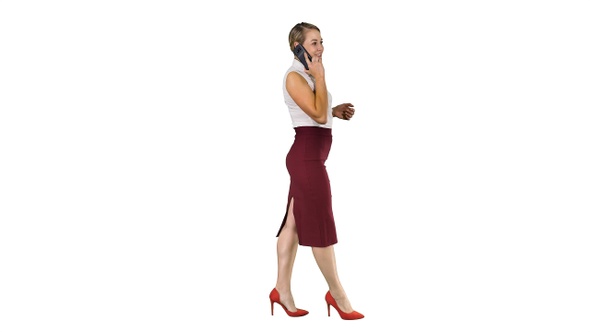 Businesswoman walking and making a call on white background.