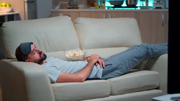 Man Closing His Eye and Falling Asleep on the Couch in Living Room