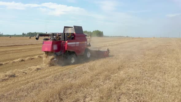 Agricultural Combine Machine Harvester Of Grain Crops On Rural Field Aerial View