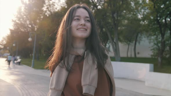 Happy girl is skateboarding at summer holidays and weekend, young woman is riding on skateboard, spo