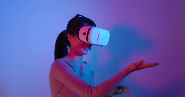 Woman looking though VR device with red and blue light