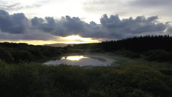 Flying Into the Sunrise Over a Peatbog in County Donegal - Ireland.