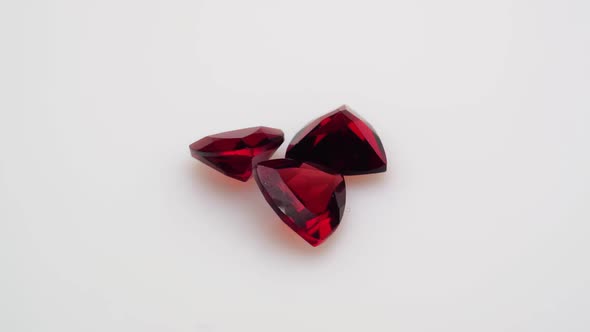 Natural Red Garnet Gemstone on the White Background on the Turning Table