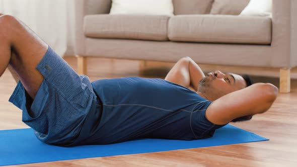 Indian Man Making Abdominal Exercises at Home