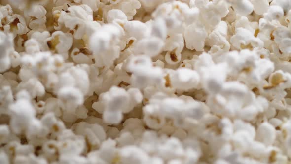 Camera follows popcorn jumping. Slow Motion. alt