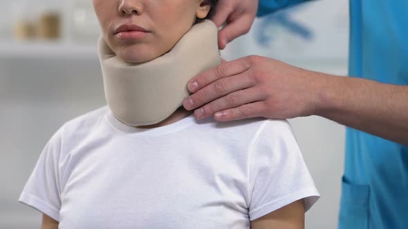 Therapist Applying Female Patient Foam Cervical Collar, Medical Support