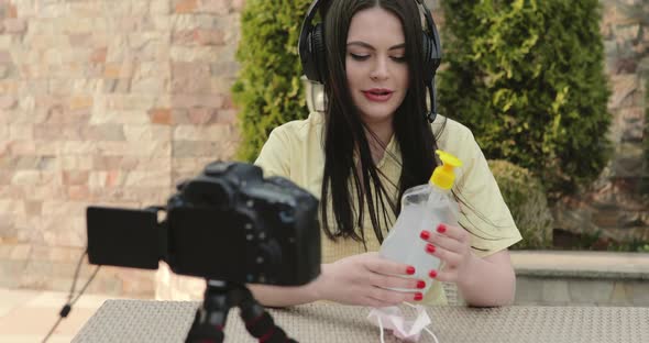 The Blogger Reviews the Disinfectant on Live Stream in Garden During a Pandemic