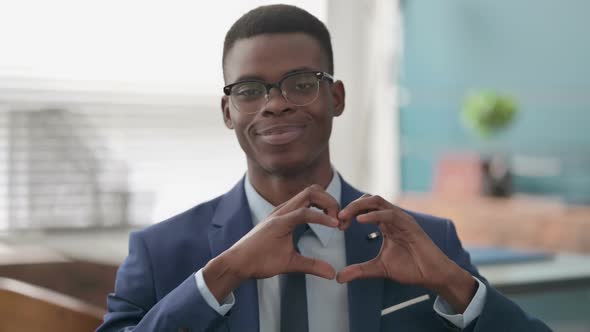 Young African Businessman Showing Heart Shape By Hands