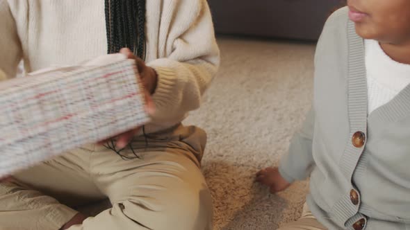 Mother Giving Present to Daughter