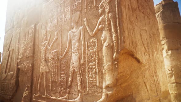 Close up of intricate carvings in the stone of a pillar in Karnak Temple, Luxor Egypt. Slow rotatio