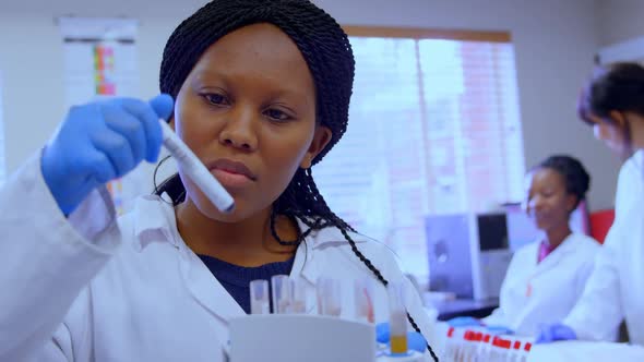 Laboratory technician checking blood sample 4k