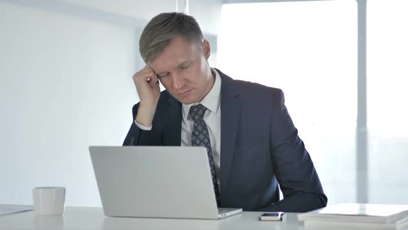 Tired Businessman Sleeping at Work