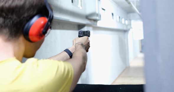 Professional Train in Shooting From a Pistol in Shooting Range