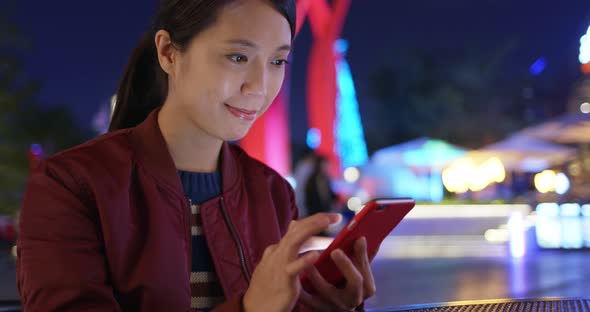 Woman Check on Smart Phone at Outdoor