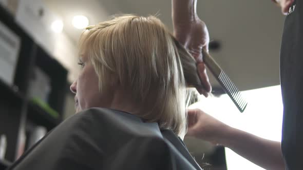 Young Woman Getting Her Hair Dressed in Hair Salon