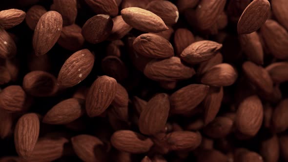 Super Slow Motion Shot of Almonds Flies After Being Exploded Against Black Background, 1000Fps.