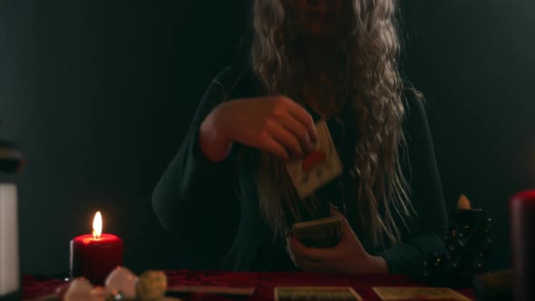 A Tarot Fortune Teller Shows a Card with the Image of a Heart Pierced By Three Swords  Three Swords