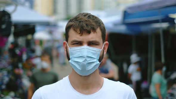 Portrait of Facemask Guy Standing on Asian Market During Coronavirus Pandemic