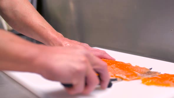 Chef Slicing Smoked Salmon Fish Fillet