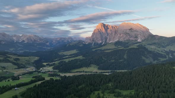 Dolomites cottages under the rugged mountains peaks at sunrise