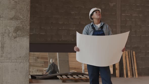 Construction Specialist Holding Large Paper