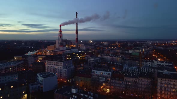 Steam From Pipes Over Night City Aerial View