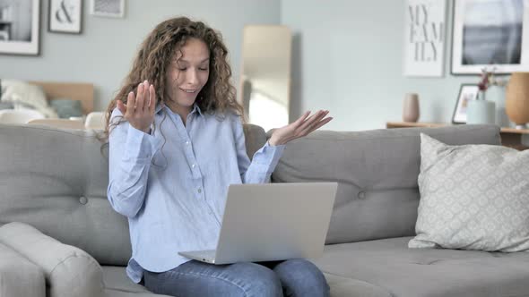Shocked Curly Hair Woman working on Laptop, Sitting on Couch