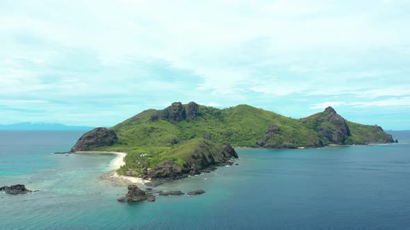 The beautiful Fiji mountain island surrounded by crystal clear waves of the sea - aerial