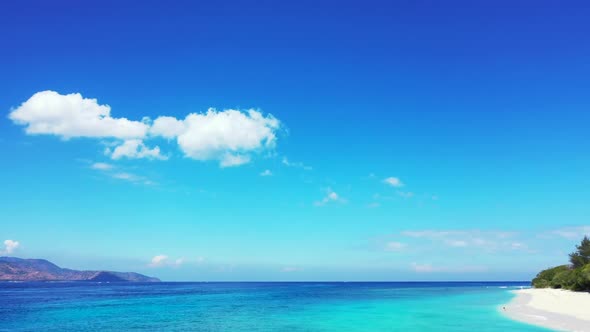 Aerial above panorama of tropical lagoon beach adventure by clear ocean and white sand background of