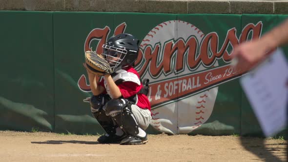 Kids playing little league baseball.