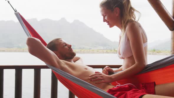 Caucasian couple spending time at home, kissing outide the cabin