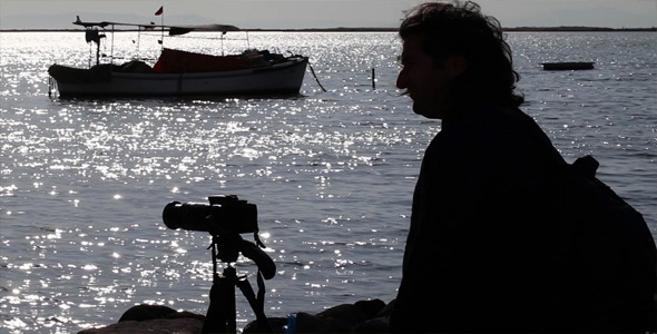 Man Taking Photo Near the Sea
