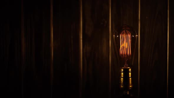 Vintage Light Bulb on a Wooden Background