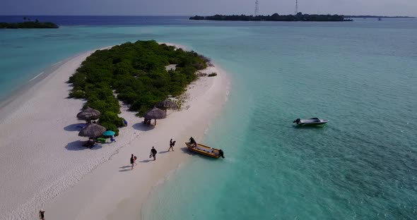 Daytime above copy space shot of a sandy white paradise beach and blue water background in hi res 4K