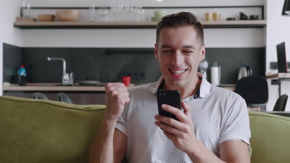 Amazed Happy Young Man Receiving Good News. Excited Overjoyed Male Winner Celebrating Success