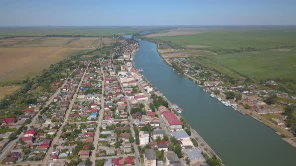 Aerial View Of Sulina City Harbor And The Danube Flowing Into The Black Sea