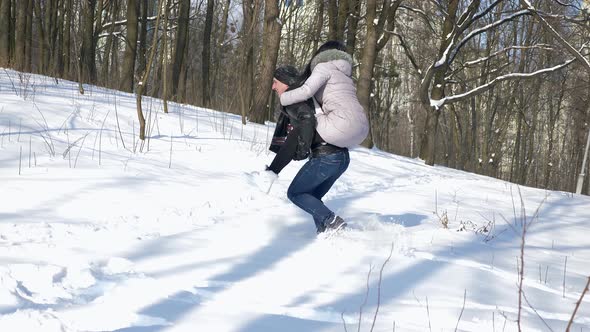 Happy Man Carrying Woman On His Back. Sunny Winter Day Slow Motion