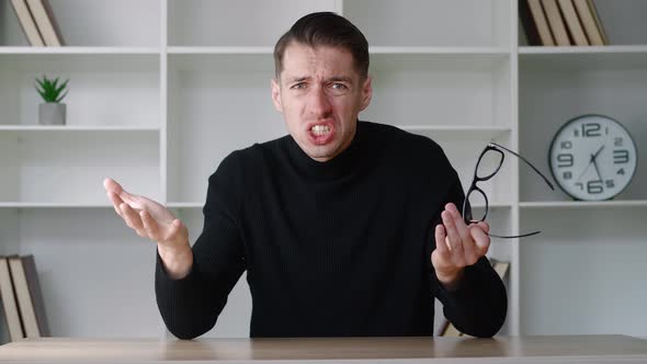 Shocked Male Businessman in White Shirt Takes Off Glasses and Say What