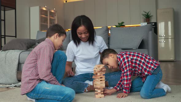 Happy Family Mother and Two Sons Having Fun Time and Playing Jango